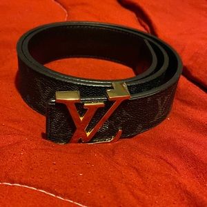 Louis Vuitton black with gold buckle and Louis Vuitton logos on it